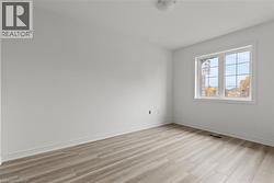 Empty room with baseboards and light wood finished floors -