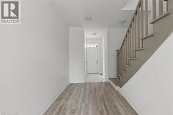 Foyer entrance featuring stairs and light wood-style floors -