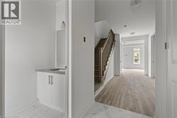 Hallway with light marble finish floors and stairs -