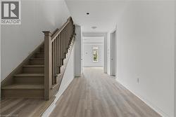 Stairway featuring wood finished floors and baseboards -