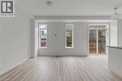 Empty room featuring light wood finished floors and baseboards -