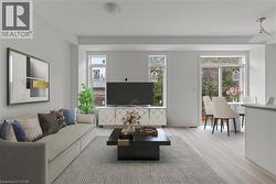 Living room with wood finished floors and baseboards -