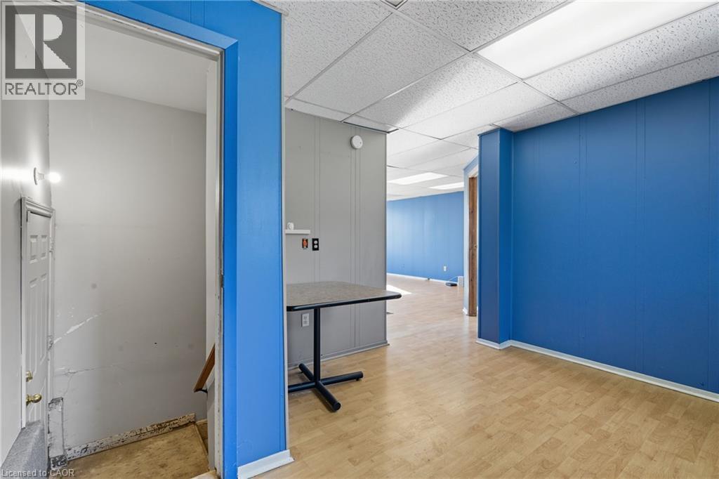 Corridor featuring light wood-type flooring and a drop ceiling - 1036 Upper Wentworth Street, Hamilton, ON