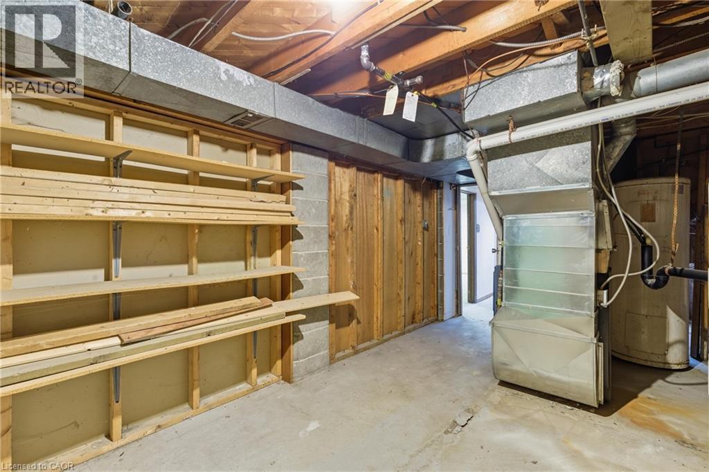 Unfinished basement with water heater and heating unit - 1036 Upper Wentworth Street, Hamilton, ON
