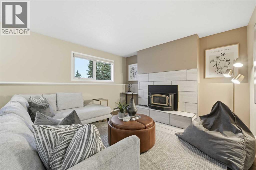 471 Dalmeny Hill Nw, Calgary, AB - Indoor Photo Showing Living Room With Fireplace