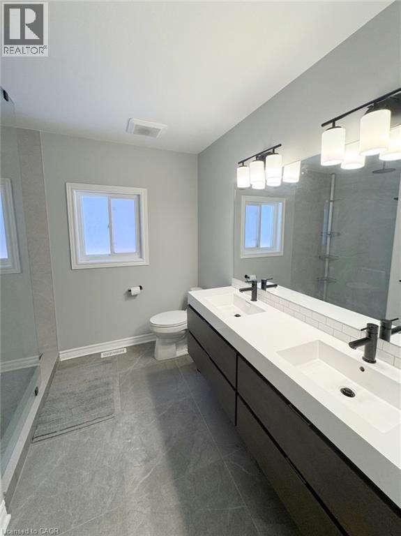 Full bathroom featuring walk in shower, double vanity, and plenty of natural light - 2429 Whitehorn Drive, Burlington, ON - Indoor Photo Showing Bathroom