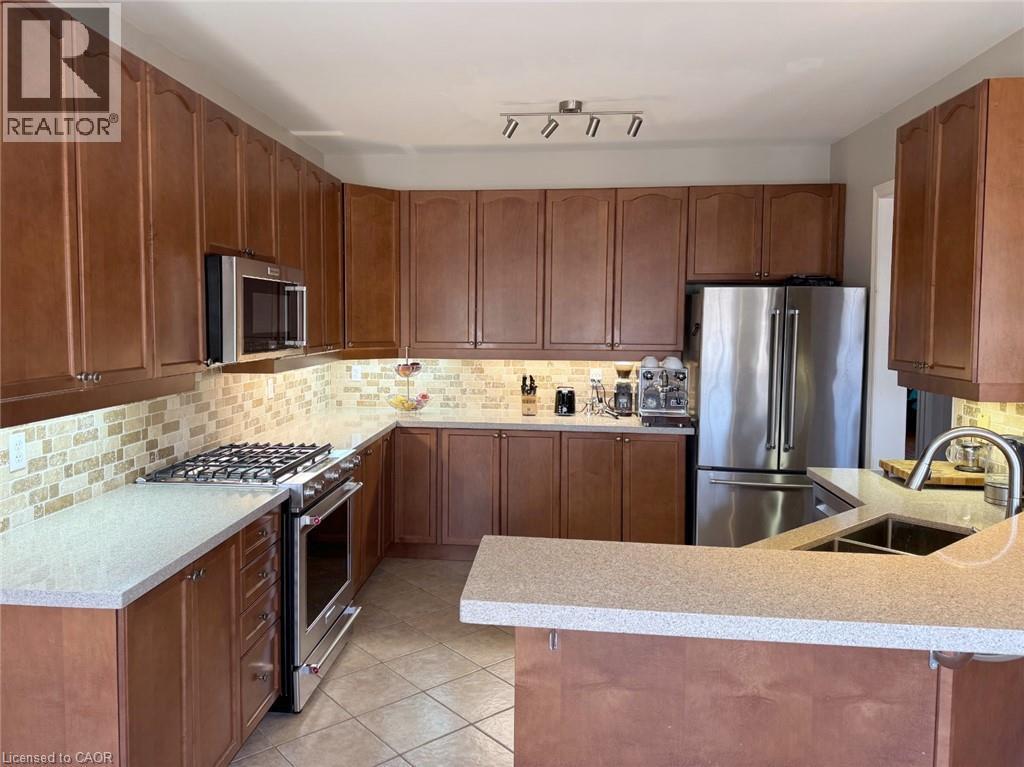 Kitchen with high end appliances, tasteful backsplash, and a peninsula - 2429 Whitehorn Drive, Burlington, ON - Indoor Photo Showing Kitchen With Double Sink With Upgraded Kitchen