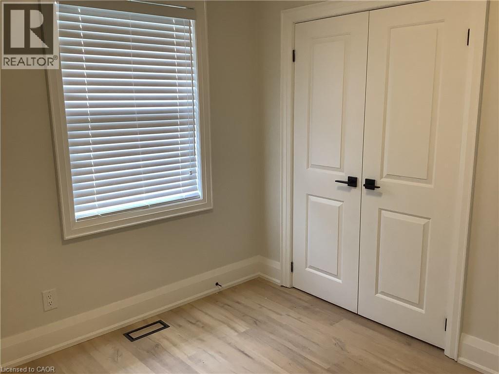 Unfurnished bedroom with light wood-type flooring and a closet - 229 West 18Th Street, Hamilton, ON - Indoor Photo Showing Other Room