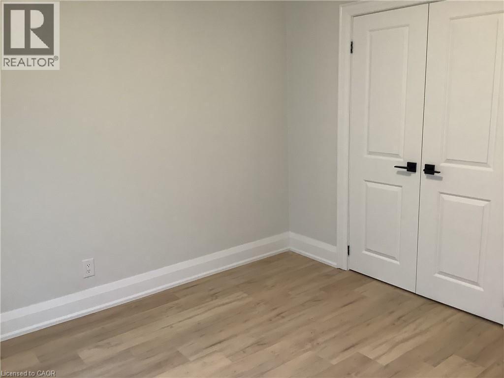 Unfurnished bedroom with light wood-type flooring and a closet - 229 West 18Th Street, Hamilton, ON - Indoor Photo Showing Other Room