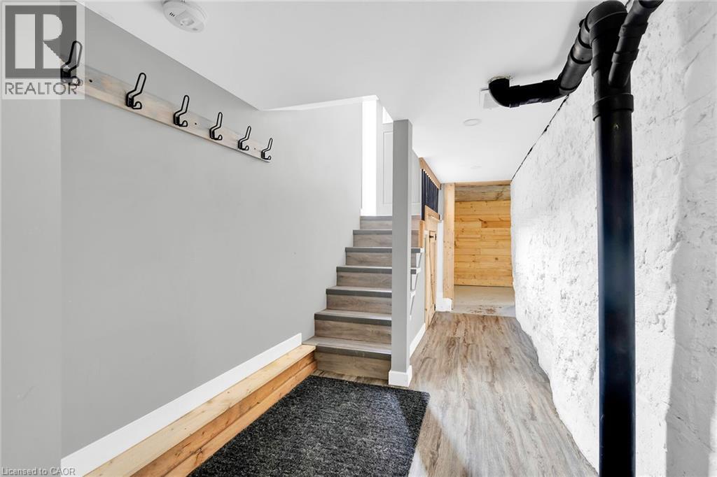 Stairs featuring wood finished floors, wood walls, and baseboards - 129 Dundurn Street N, Hamilton, ON - Indoor Photo Showing Other Room