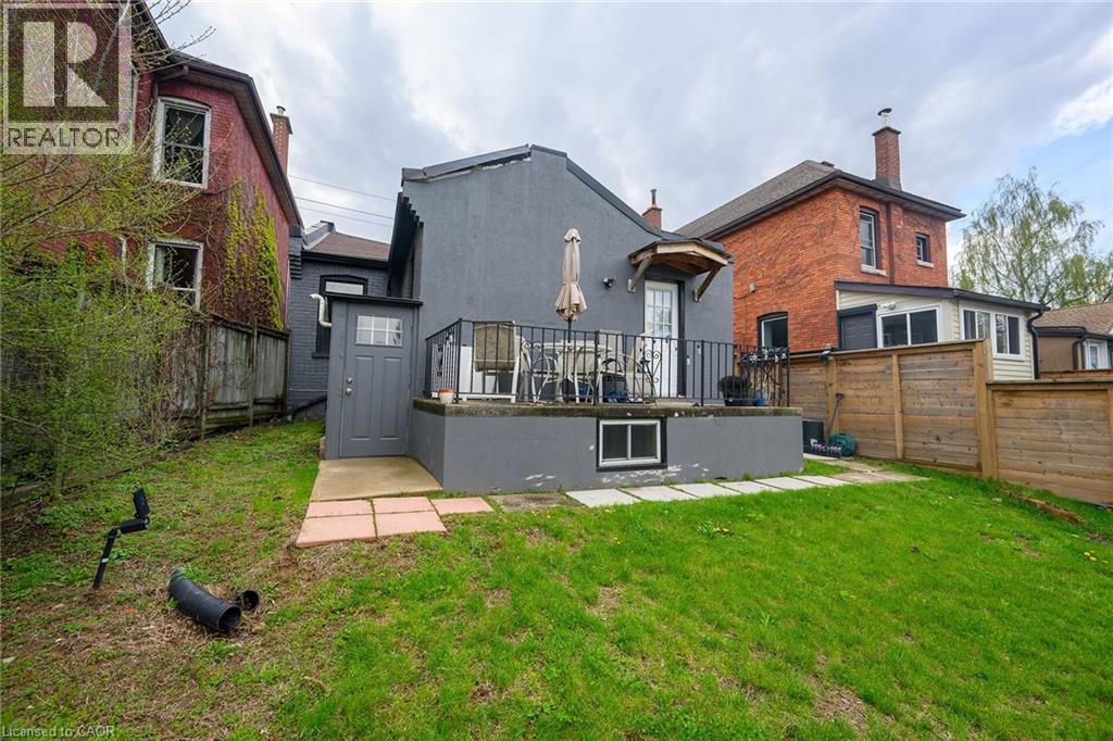 Rear view of house with a chimney and brick siding - 129 Dundurn Street N, Hamilton, ON - Outdoor