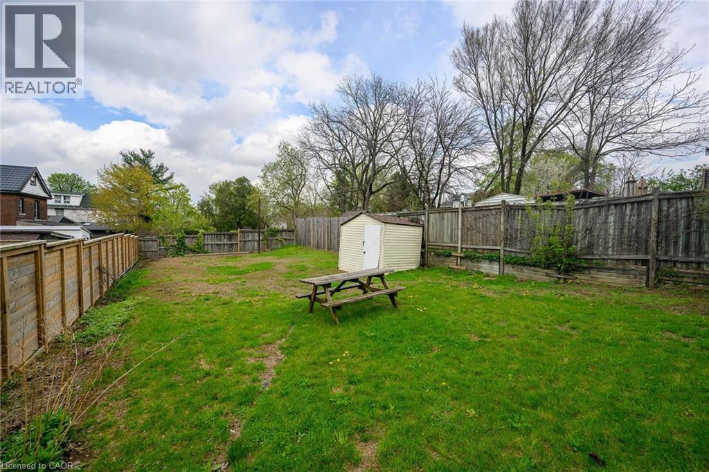 View of yard featuring a storage unit and an outbuilding - 129 Dundurn Street N, Hamilton, ON - Outdoor With Backyard