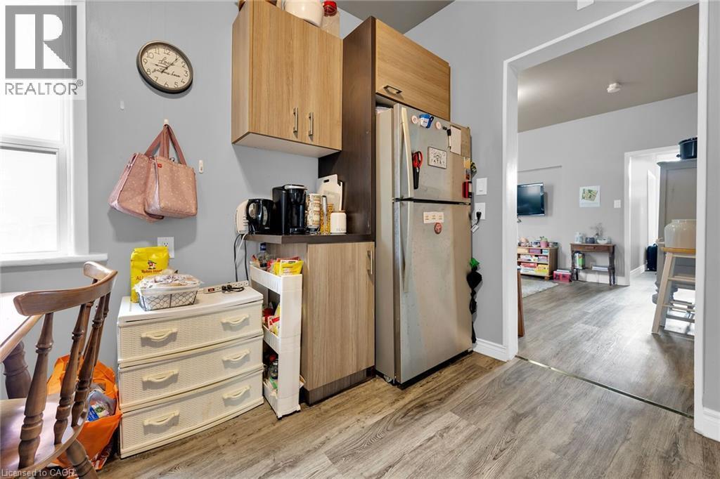 Kitchen with freestanding refrigerator and light wood-style floors - 129 Dundurn Street N, Hamilton, ON - Indoor