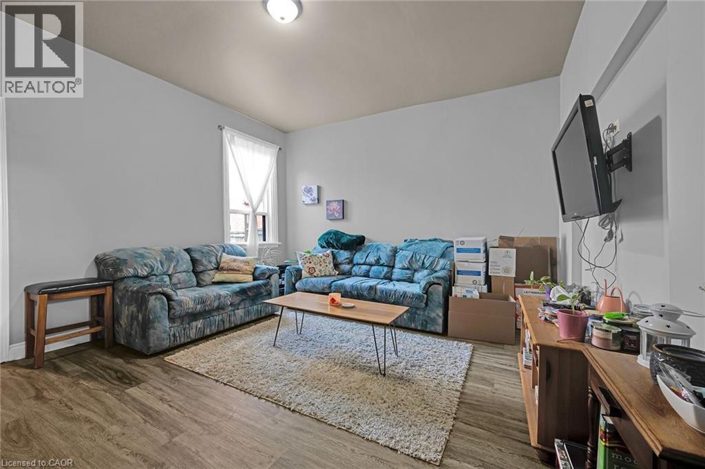 Living area featuring wood finished floors - 129 Dundurn Street N, Hamilton, ON - Indoor Photo Showing Living Room