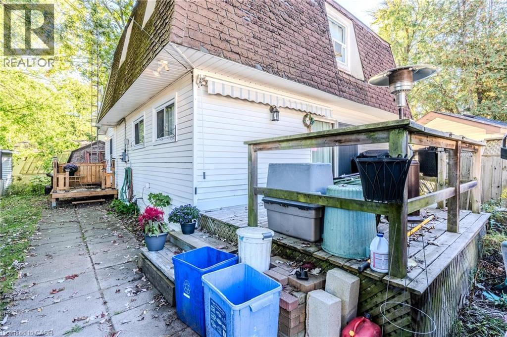 View of side of property featuring a shingled roof, mansard roof, and a deck - 57 12Th Conc Road E Unit# 430, Flamborough, ON - Outdoor With Deck Patio Veranda With Exterior