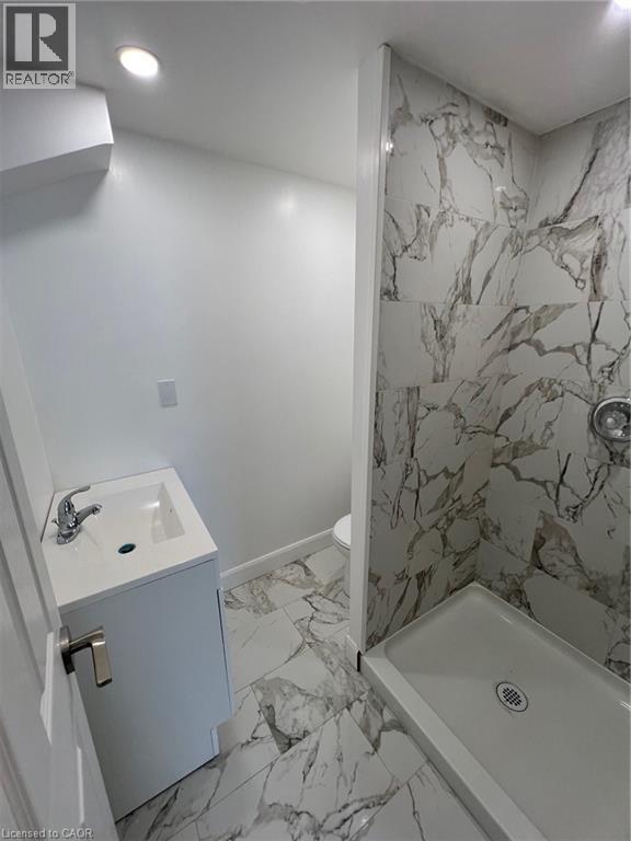 Full bath with light marble finish flooring, vanity, a marble finish shower, and recessed lighting - 612 Upper James Street, Hamilton, ON