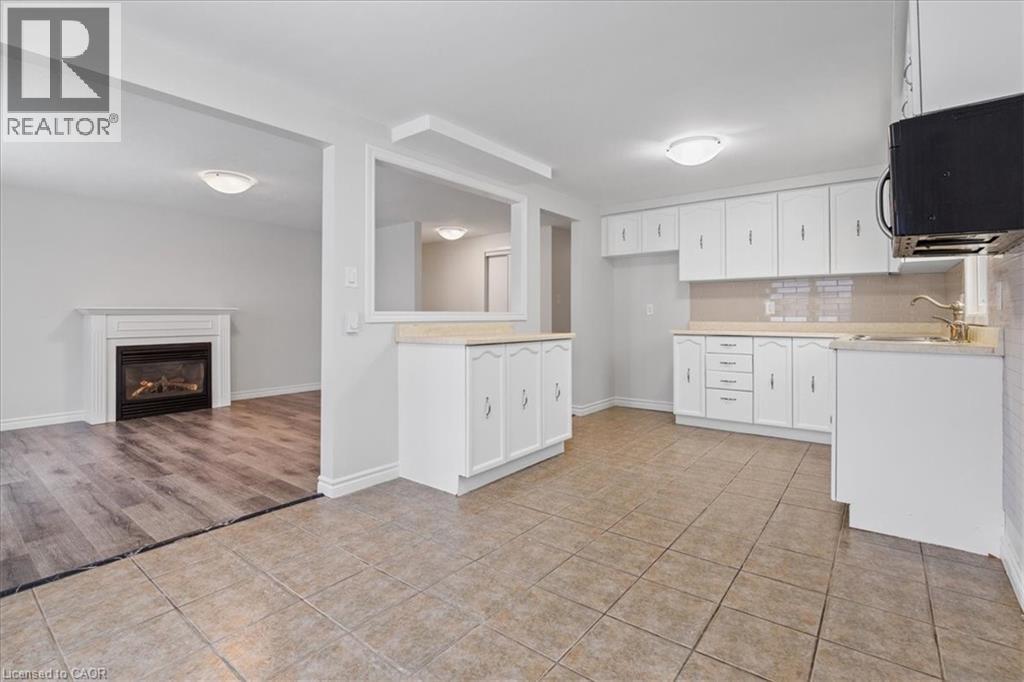 67 Old Carriage Drive, Kitchener, ON - Indoor Photo Showing Kitchen With Fireplace