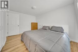 Bedroom with light wood-style floors and baseboards -