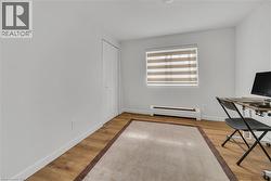 Unfurnished office featuring baseboard heating and light wood-style flooring -