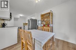 Dining area with light wood-type flooring and baseboards -