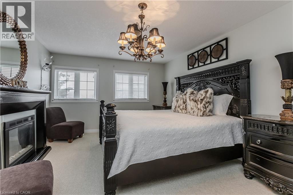 26 Grassyplain Drive, Mount Hope, ON - Indoor Photo Showing Bedroom With Fireplace