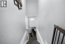 Stairs featuring baseboards and a towering ceiling -