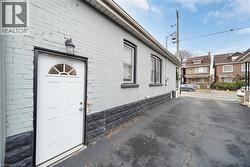 View of exterior entry with brick siding -
