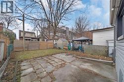 Fenced backyard featuring a gazebo, a patio area, and a residential view -