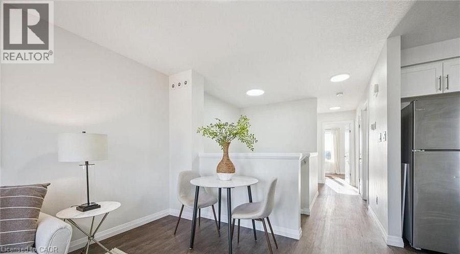 Dining room featuring dark wood-style flooring and recessed lighting - 24 Morrison Road Unit# D9, Kitchener, ON - Indoor