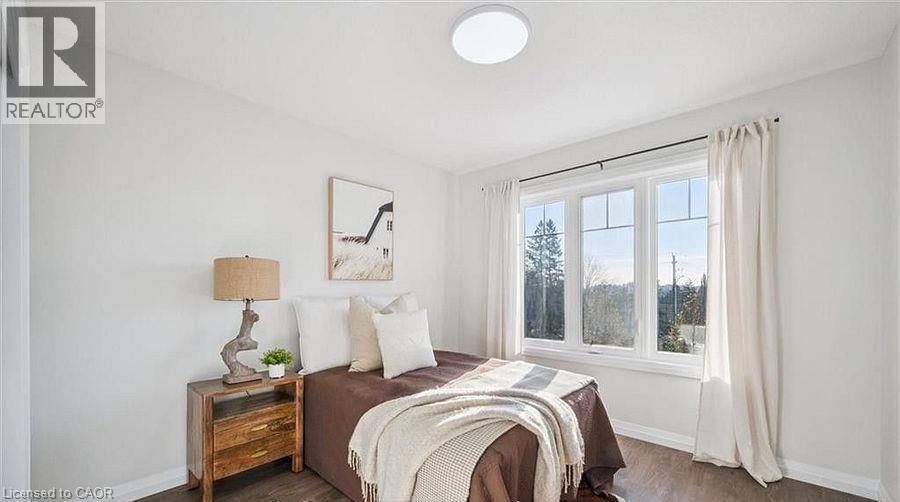 Bedroom featuring dark wood finished floors and baseboards - 24 Morrison Road Unit# D9, Kitchener, ON - Indoor Photo Showing Bedroom