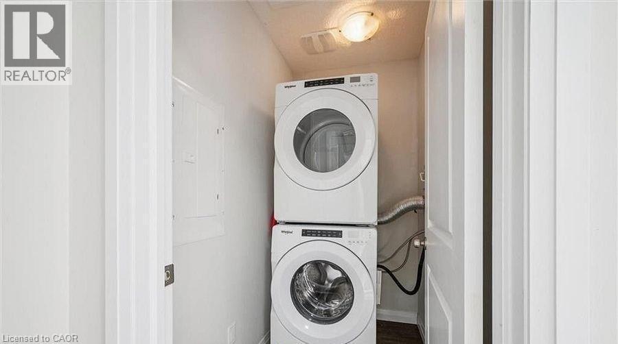 Laundry room featuring stacked washing machine and dryer - 24 Morrison Road Unit# D9, Kitchener, ON - Indoor Photo Showing Laundry Room