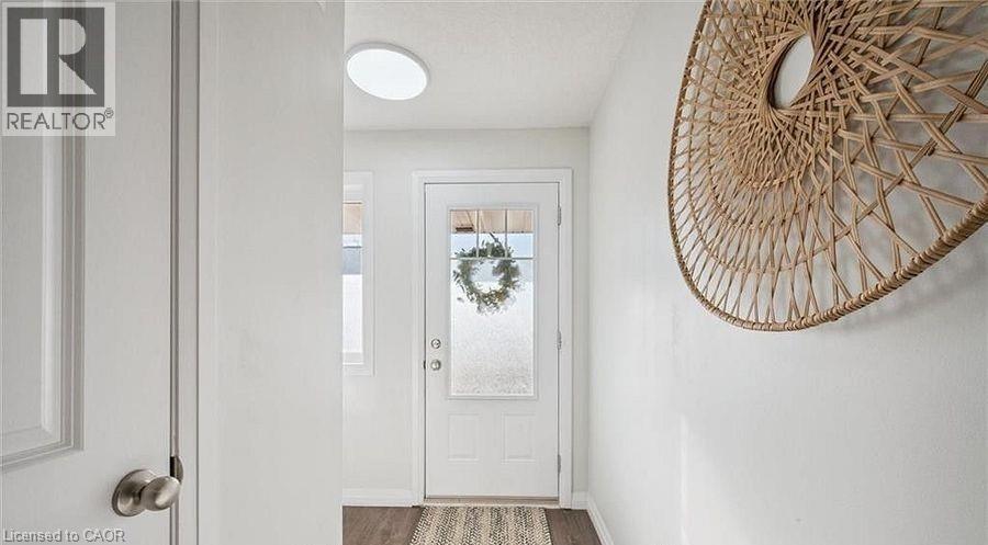 Doorway to outside featuring baseboards and wood finished floors - 24 Morrison Road Unit# D9, Kitchener, ON - Indoor Photo Showing Other Room