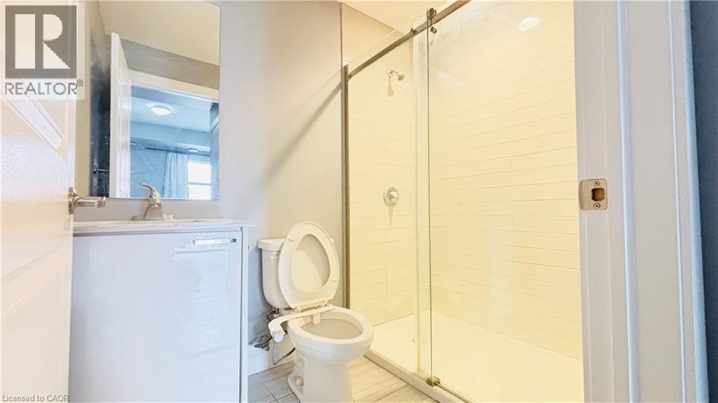 Bathroom featuring vanity, a shower stall, and tile patterned floors - 155 St. Leger Unit# 107, Kitchener, ON - Indoor Photo Showing Bathroom