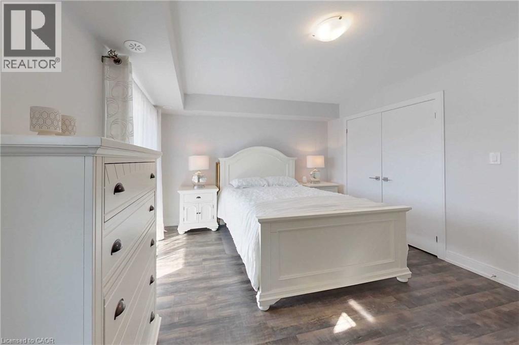 Bedroom with a closet and dark wood-type flooring - 588 Rapids Lane, Mississauga, ON - Indoor Photo Showing Bedroom