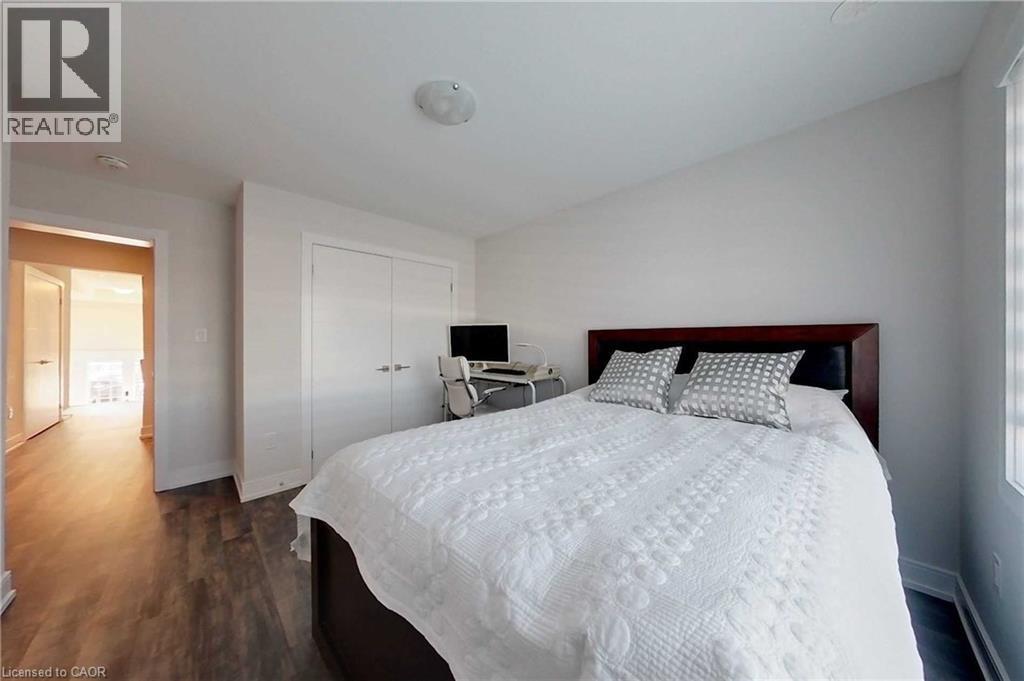Bedroom featuring dark wood-style flooring and a closet - 588 Rapids Lane, Mississauga, ON - Indoor Photo Showing Bedroom