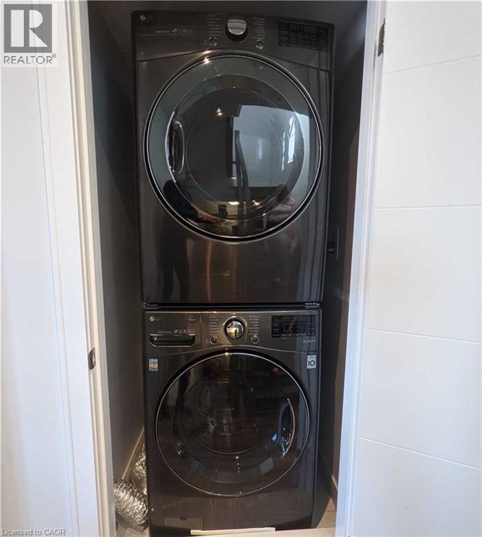 Laundry room with stacked washer / dryer - 588 Rapids Lane, Mississauga, ON - Indoor Photo Showing Laundry Room