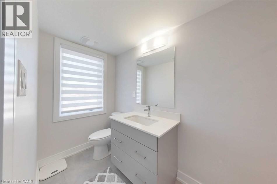 Half bath featuring vanity and baseboards - 588 Rapids Lane, Mississauga, ON - Indoor Photo Showing Bathroom