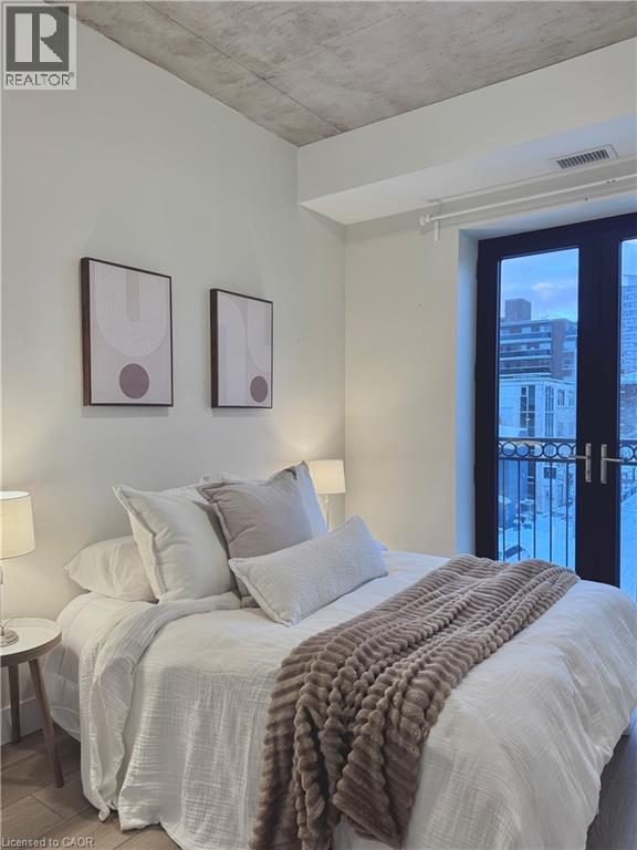 PRIMARY BEDROOM WITH JULIET BALCONY (WEST FACING WINDOWS) - 169 James Street S Unit# 401, Hamilton, ON - Indoor Photo Showing Bedroom
