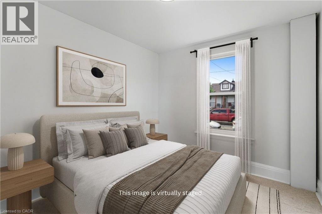 Main Floor Bedroom (Virtually Staged) - 159 Hope Avenue, Hamilton, ON - Indoor Photo Showing Bedroom