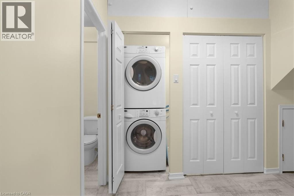 Laundry area with stacked washer / dryer - 90 Westlawn Drive, Hamilton, ON - Indoor Photo Showing Laundry Room