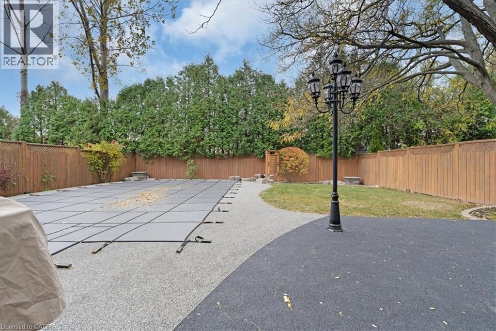 View of swimming pool with a fenced backyard and rubber paved patio - 90 Westlawn Drive, Hamilton, ON - Outdoor
