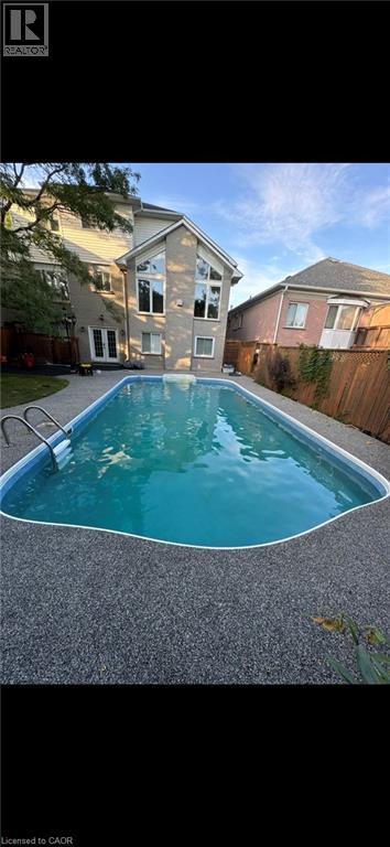 View of pool with a fenced backyard and french doors - 90 Westlawn Drive, Hamilton, ON - Outdoor With In Ground Pool With Backyard