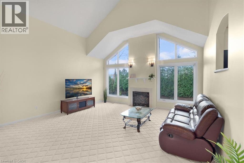family room with high vaulted ceiling, light carpet, plenty of natural light, and a gas fireplace - 90 Westlawn Drive, Hamilton, ON - Indoor