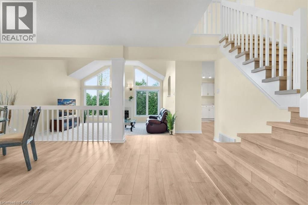 hallway with dining room to left, staircase to bedroom level to right, family room straight ahead - 90 Westlawn Drive, Hamilton, ON - Indoor Photo Showing Other Room