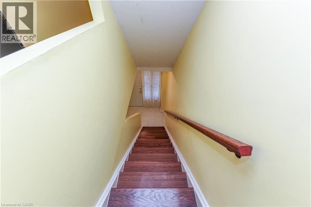 Stairway with wood finished floors and a textured ceiling - 85 Enmount Drive, Brampton, ON - Indoor Photo Showing Other Room