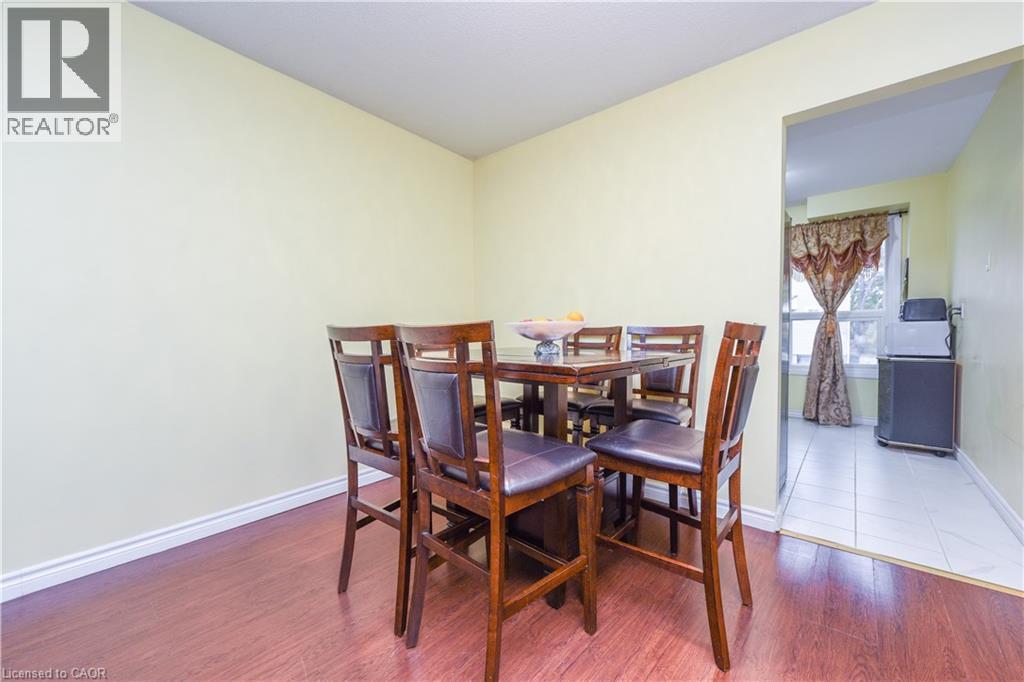 Dining area with wood finished floors and baseboards - 85 Enmount Drive, Brampton, ON - Indoor Photo Showing Other Room