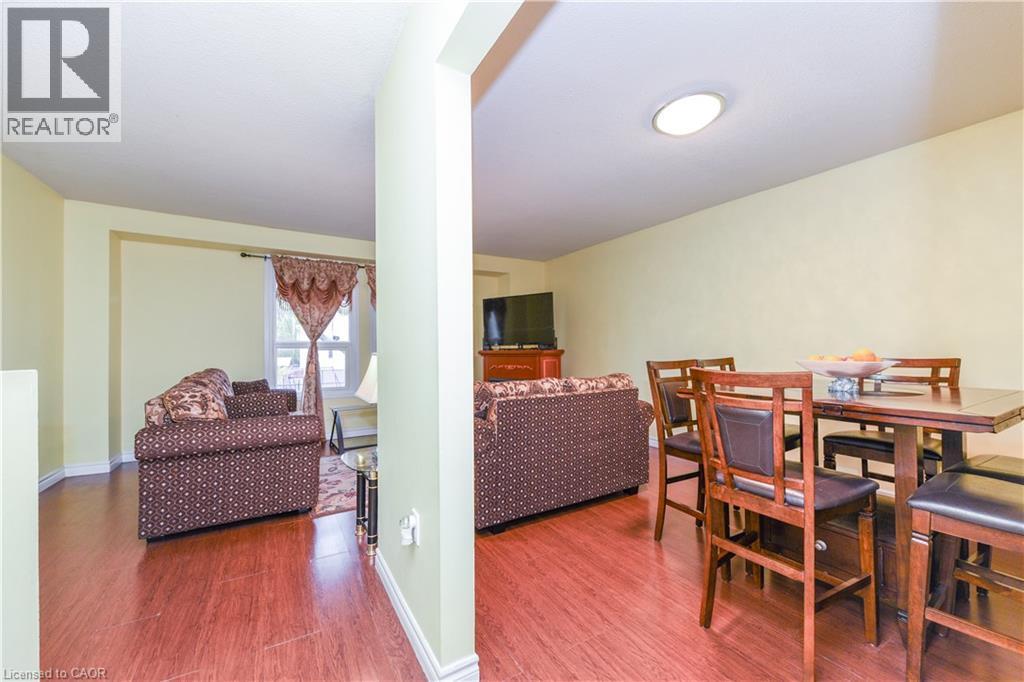 Dining room featuring wood finished floors and baseboards - 85 Enmount Drive, Brampton, ON - Indoor
