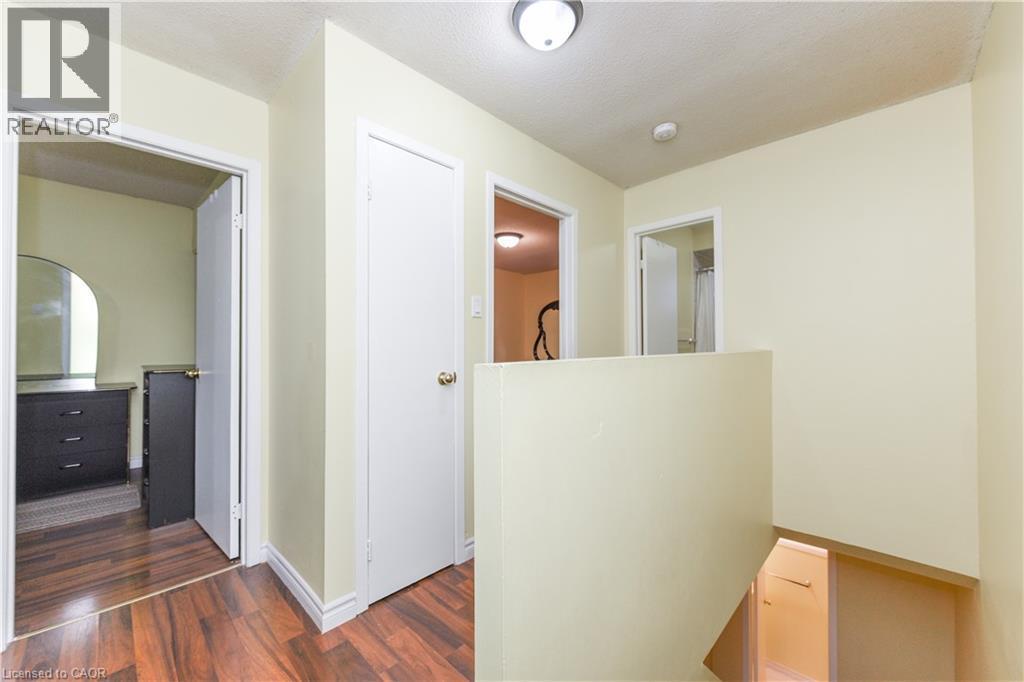Corridor featuring dark wood-style floors and a textured ceiling - 85 Enmount Drive, Brampton, ON - Indoor Photo Showing Other Room