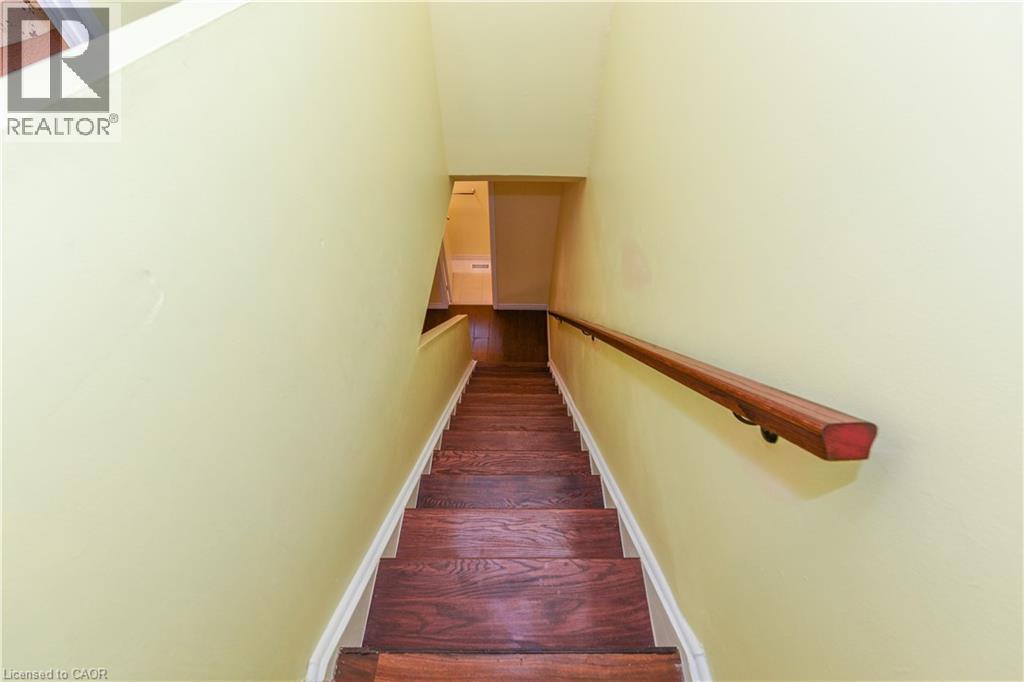 Stairway with wood finished floors and baseboards - 85 Enmount Drive, Brampton, ON - Indoor Photo Showing Other Room
