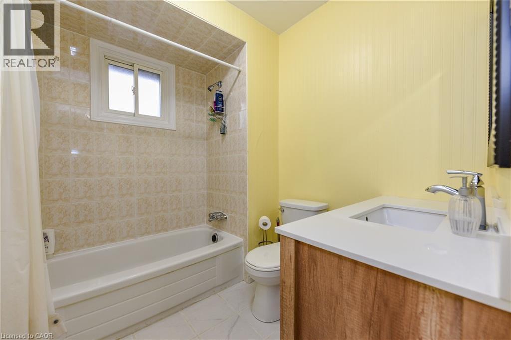 Full bathroom with vanity, shower / tub combo with curtain, and light tile patterned flooring - 85 Enmount Drive, Brampton, ON - Indoor Photo Showing Bathroom
